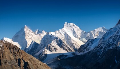 Fototapeta premium A mountain range with snow on the peaks and a clear blue sky
