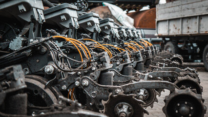 Agricultural Machinery. Close-up view of agricultural machinery components, focusing on the mechanical parts and hydraulic systems.