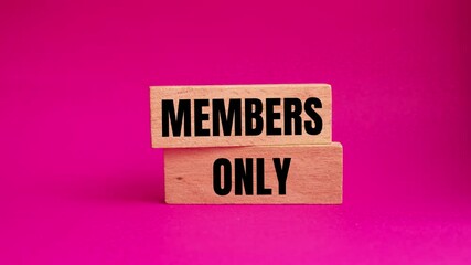 Members only message writing on wooden blocks on pink background. Conceptual members only symbol.