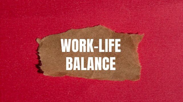 Work life balance message writing on ripped torn brown paper on red background. Conceptual work life balance symbol.