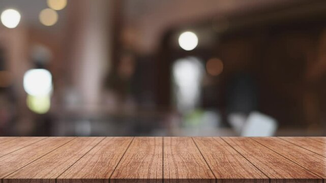 Empty wooden table top with lights bokeh on blur restaurant background