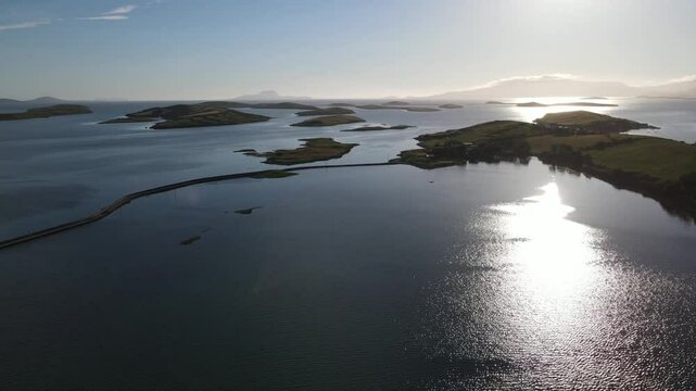 Drone shot showing a winding road through the water and islands. Westport, Mayo, Ireland
