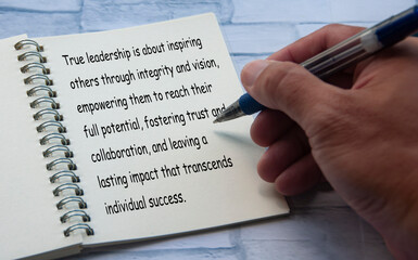 True leaderships text written on notepad. Leadership concept