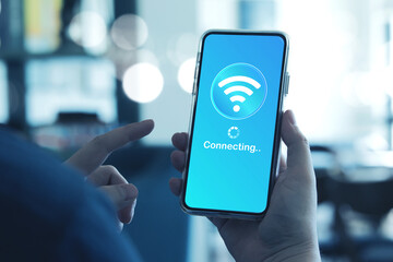Man using smartphone connects to wireless fidelity (Wi-Fi) internet on smartphone. Concepts of technological, wireless network connections, security cyber, and WiFi encryption.