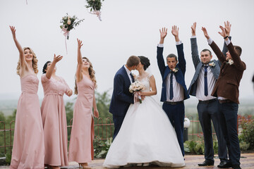A group of people are celebrating a wedding, with the bride