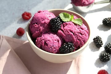 Delicious blackberry sorbet, mint and fresh berries on grey table, closeup