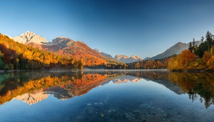 Fototapeta premium Serene Autumn Mountain Landscape with Reflective Lake and Vibrant Foliage at Sunrise