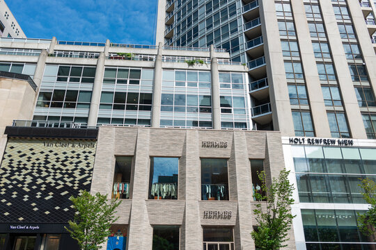 frontal view of Van Cleef & Arpels, a jewelry store, and Herm&egrave;s, a clothing store, located at 100 Bloor Street West in Toronto, Canada