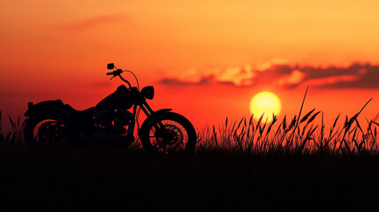 Obraz premium Silhouette of a motorcycle in a grassy field against a fiery sunset sky