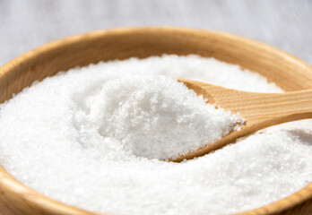 Salt in a wooden spoon close-up.