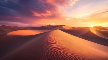 An expansive desert landscape at sunset, where the sand dunes are painted with shades of deep orange, pink, and purple.
