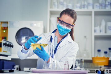 Beaker, chemical and scientist with goggles in laboratory for pharmaceutical development or...
