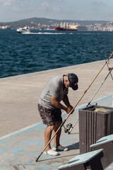 Man fishing on a sunny day by the sea in ıstanbul, turkey