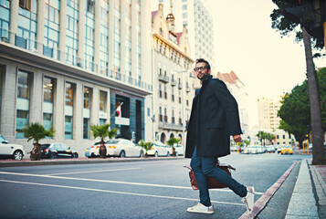 Fashion, commute and man in city, stylish clothes and pedestrian in street, startup owner and urban town. Person, glasses and guy in road, walking and New York with portrait, buildings and travel