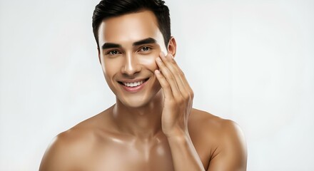 portrait of a person, man smiling while touching his flawless glowy skin