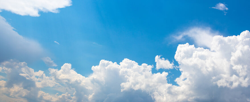 Blue sky with white curly clouds