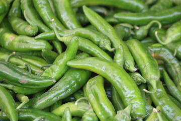close up of green peppers on market