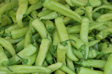close up of green peppers on market