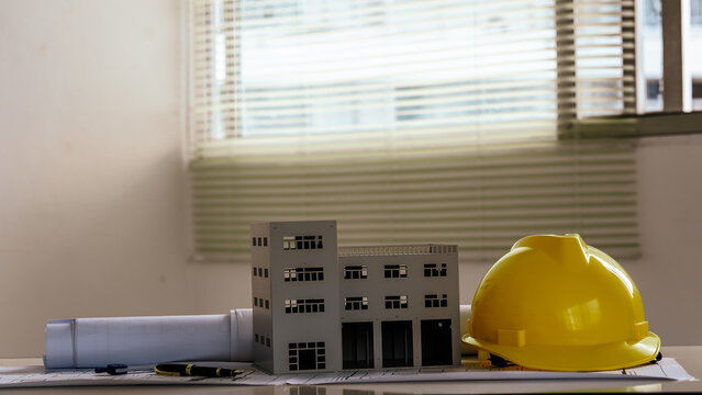 Architects concept, engineer architect designer freelance work on start-up project drawing, construction plan architect design working drawing sketch plans blueprints and making construction model.