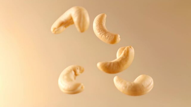 Cashew nuts gracefully floating against a warm, colorful backdrop during harvest season