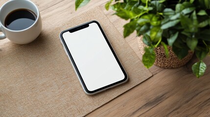 Modern Workspace with Mobile Phone, Coffee, and Plant on Desk