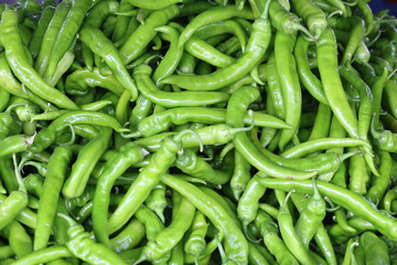 close up of green peppers on market