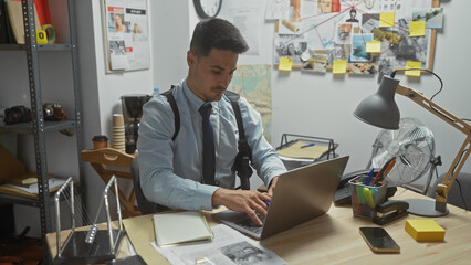 Focused man in detective office with laptop, evidence board, desk, investigation, indoor, adult, work, serious, documents, analyzing