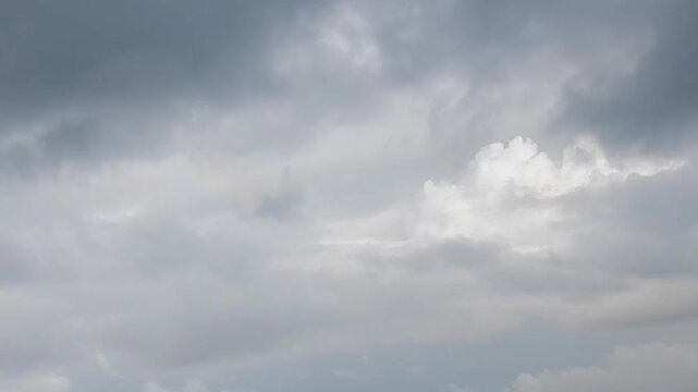 Flight in clouds during changeable cloudy and sunny summer weather with colorful arc of rainbow, rainy clouds and blue sky - aerial background. Topics: weather, meteorology, optical phenomenon
