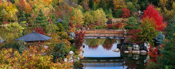 Panoramic view of Walking bridge in scenic Frederik Meijer gardens in autumn time in Grand Rapids, Michigan.