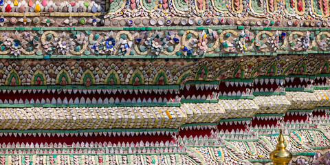 Colorful intricate decor on historic Thailand temple close up view.