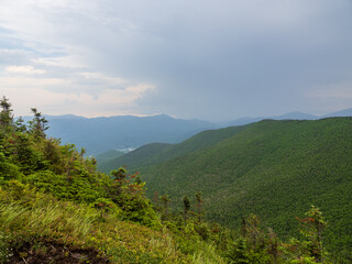 View from the summit of Cascade Mountain, Lake Placid, Adirondacks, New York State with light breaking through heavy clouds.