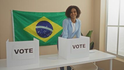 Young african american woman voting in an electoral college room with a brazilian flag in the...