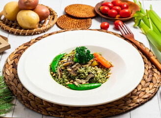 Pine nut pesto risotto with vegetables broccoli, mushroom, peas and carrot in plate isolated on table side view of taiwan food