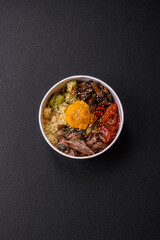 Bowl of food with beef, bulgur, tomatoes, mushrooms, zucchini