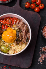 Bowl of food with beef, bulgur, tomatoes, mushrooms, zucchini