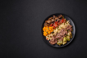 Bowl of food with beef, bulgur, tomatoes, mushrooms, zucchini