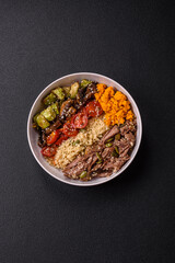 Bowl of food with beef, bulgur, tomatoes, mushrooms, zucchini