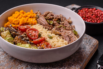 Bowl of food with beef, bulgur, tomatoes, mushrooms, zucchini