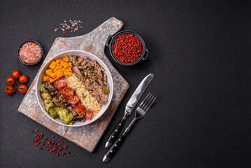 Bowl of food with beef, bulgur, tomatoes, mushrooms, zucchini