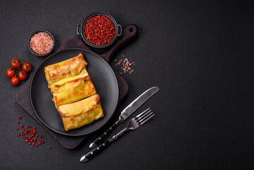 Homemade fried pancakes with filling on a ceramic plate