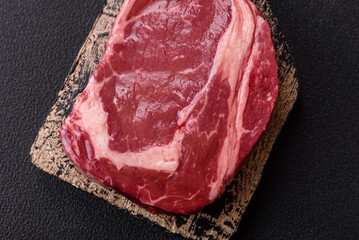Fresh, raw beef steak with salt, spices and herbs