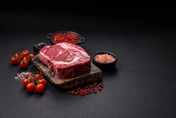 Fresh, raw beef steak with salt, spices and herbs