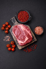 Fresh, raw beef steak with salt, spices and herbs