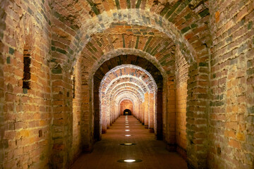 Old underground tunnel with brickwork. Stone tunnel with perspective.