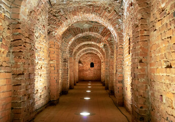 Old underground tunnel with brickwork. Stone tunnel with perspective.