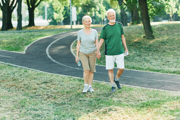 Obraz premium woman senior man outdoor running couple lifestyle sport smiling together jogging healthy nature fit happy active retirement exercise fitness run