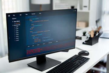 Program coding showing on pc monitor standing on desk working with empty developing engineer at...