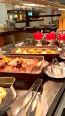 Tempting restaurant buffet filled with delicious food options, including roasted vegetables in cast iron plates, hearty gravies, and juicy roasted beef. Clean plates invite guests to savor every bite.