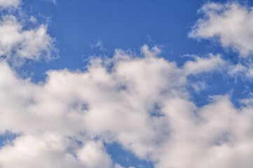 Cloudscape with white fluffy clouds in sky