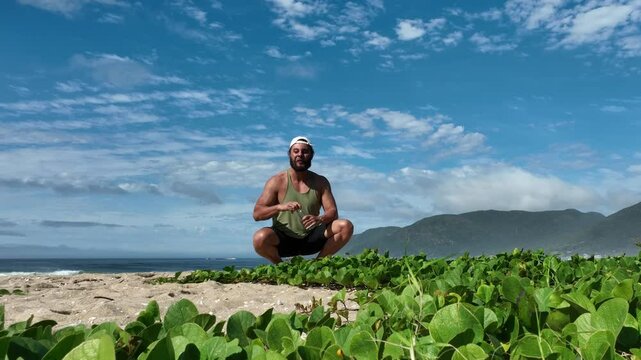 Man on a sunny day at the beach having a picnic, eating and drinking water. Outdoor concept.